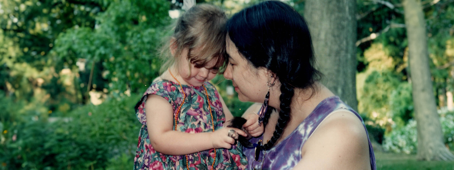 A mother and a daughter standing outside